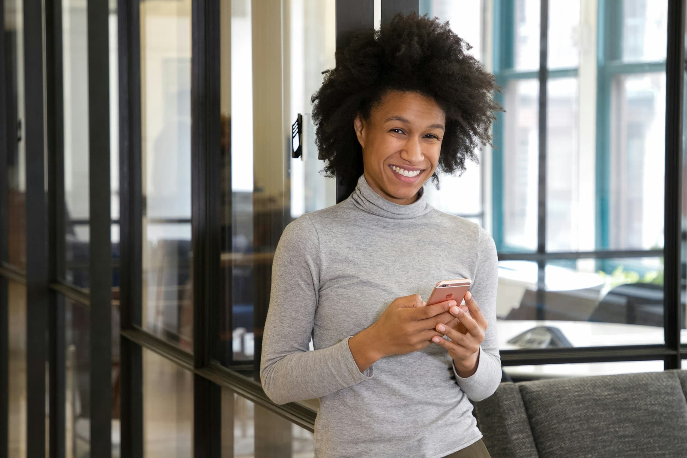 Investor reviewing her ledger-backed portfolio balance on her phone.